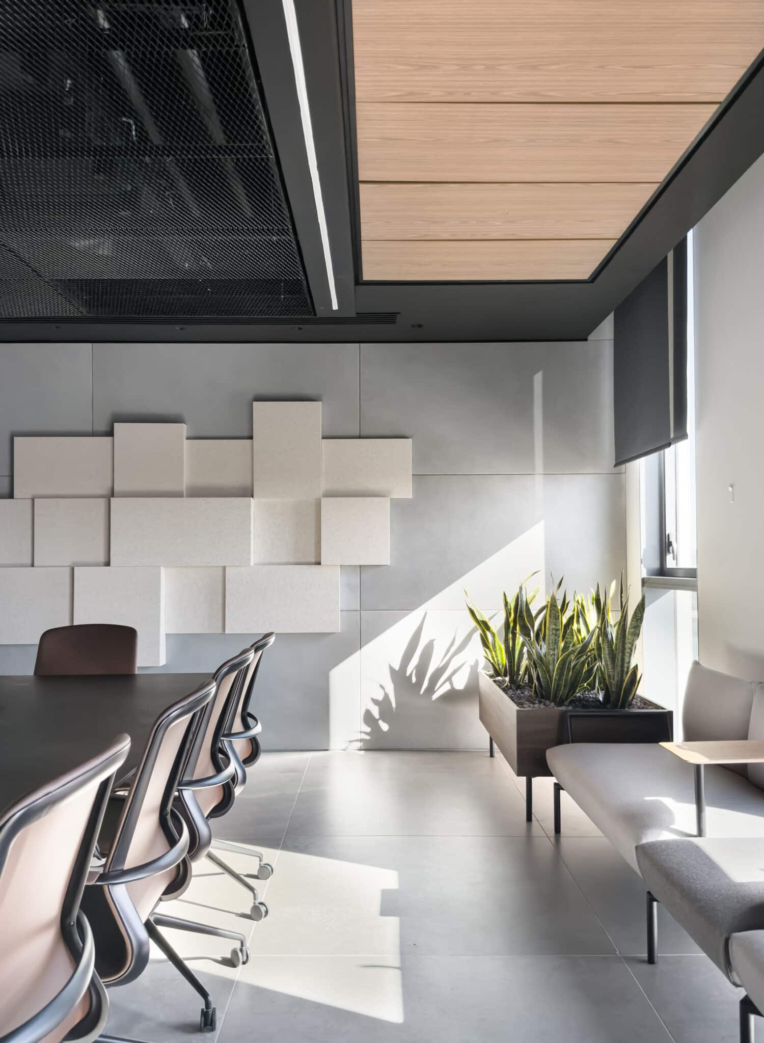 3D acoustic block panels stepped across a meeting room wall