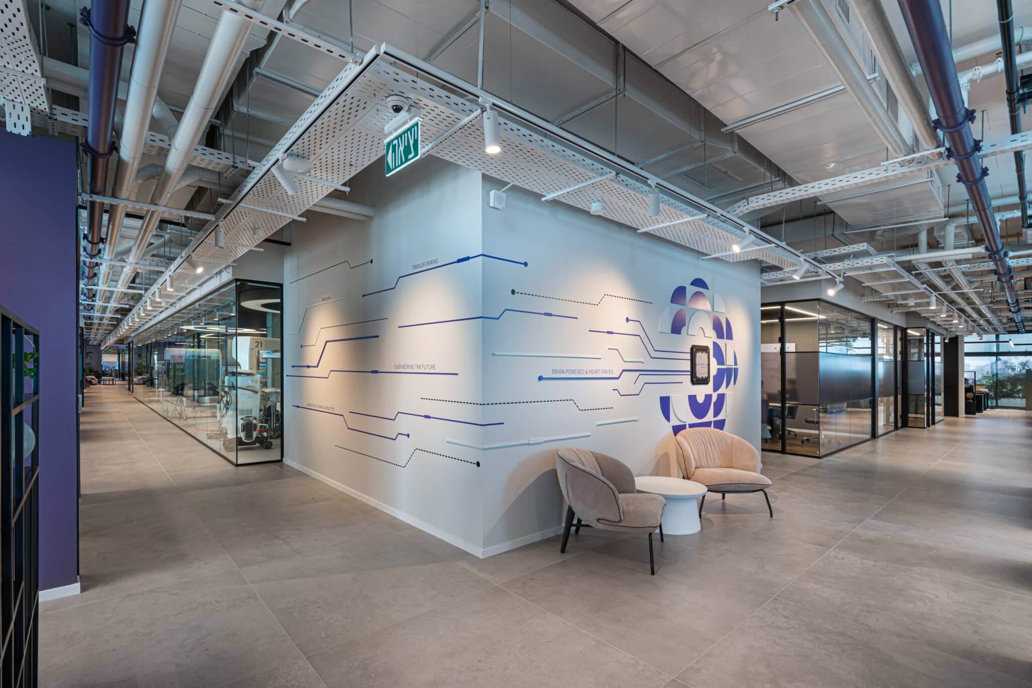 Circuit graphic wrapping a corner wall above two armchairs