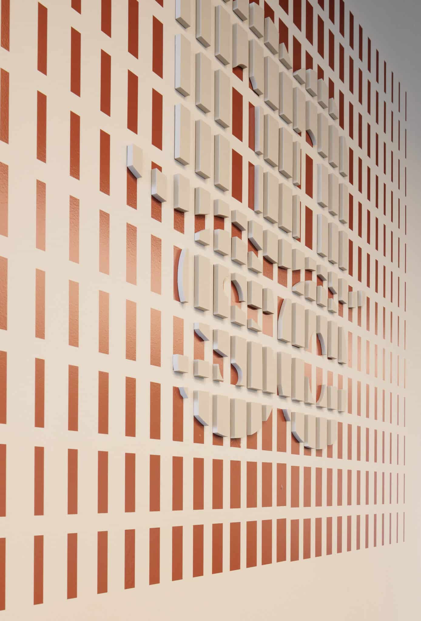 Angled view of 3D bars forming a logo in terracotta and cream