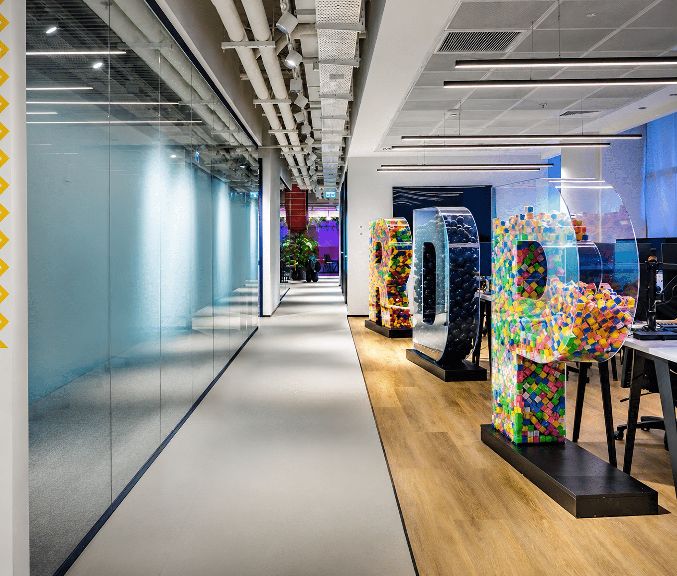 Letter sculptures filled with colourful bricks along a corridor