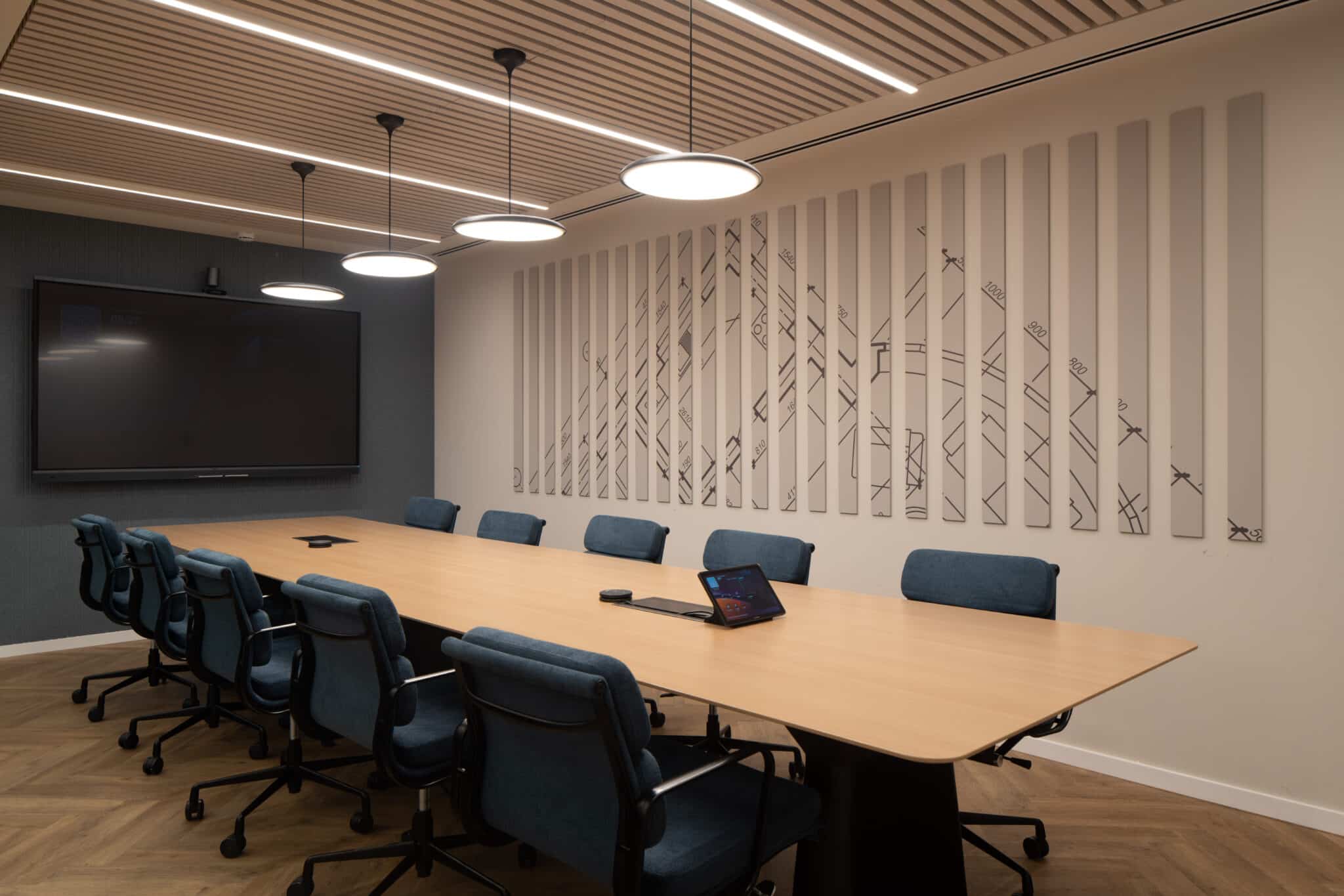 Vertical wall panels with a cut line pattern in a meeting room