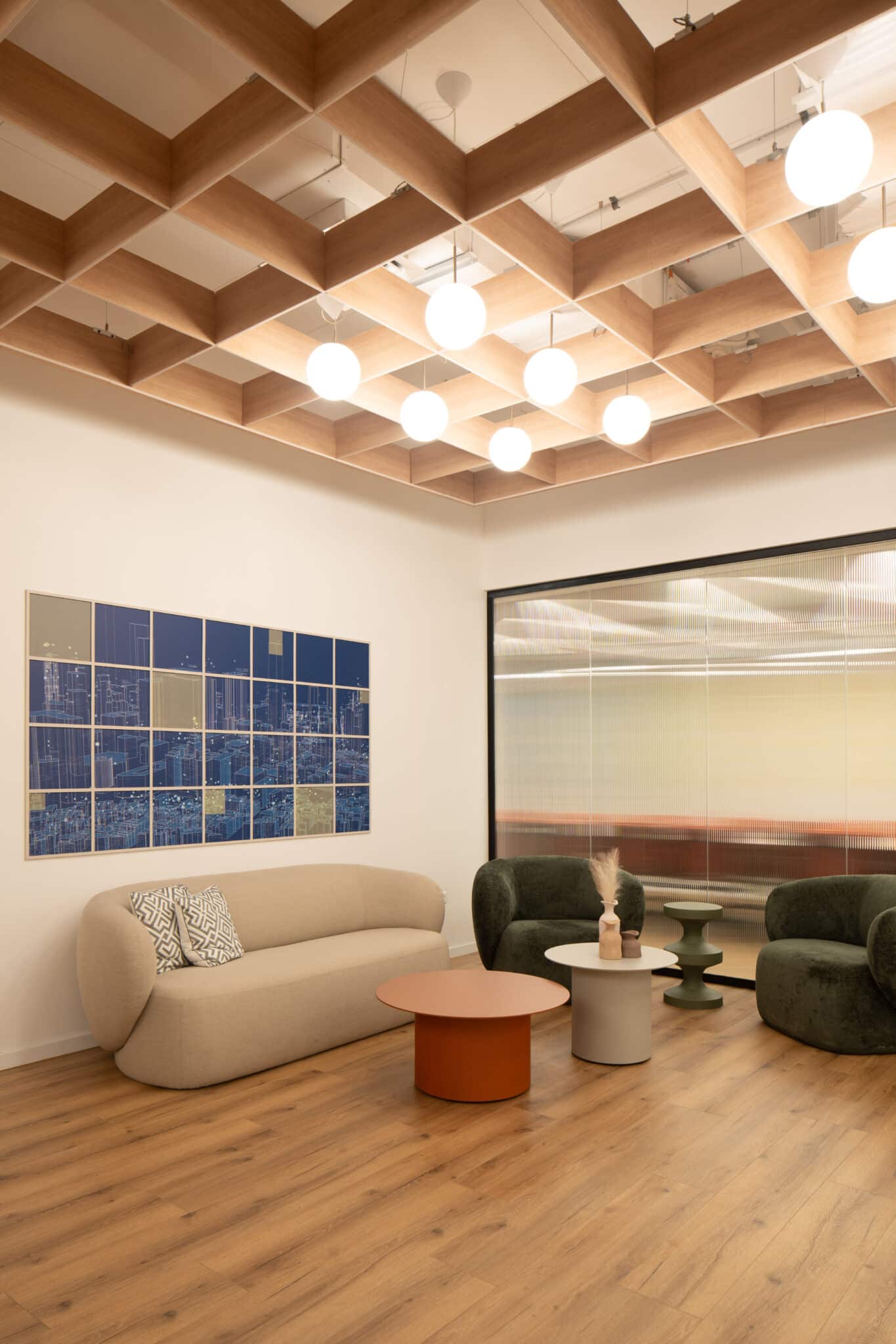 Framed blue tile artwork above a lounge sofa under a coffered ceiling