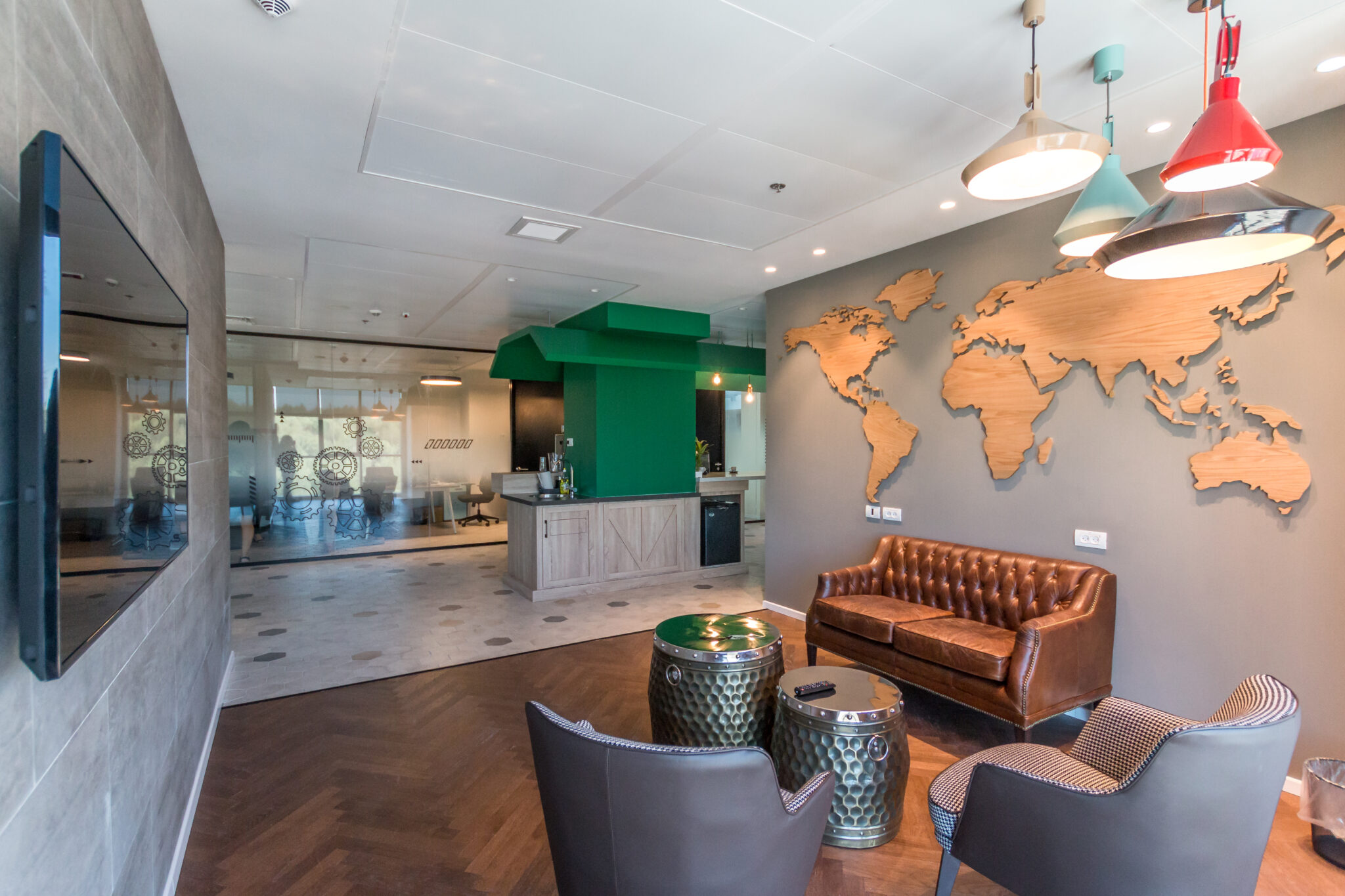 Cut wood world map filling a grey wall in the lounge