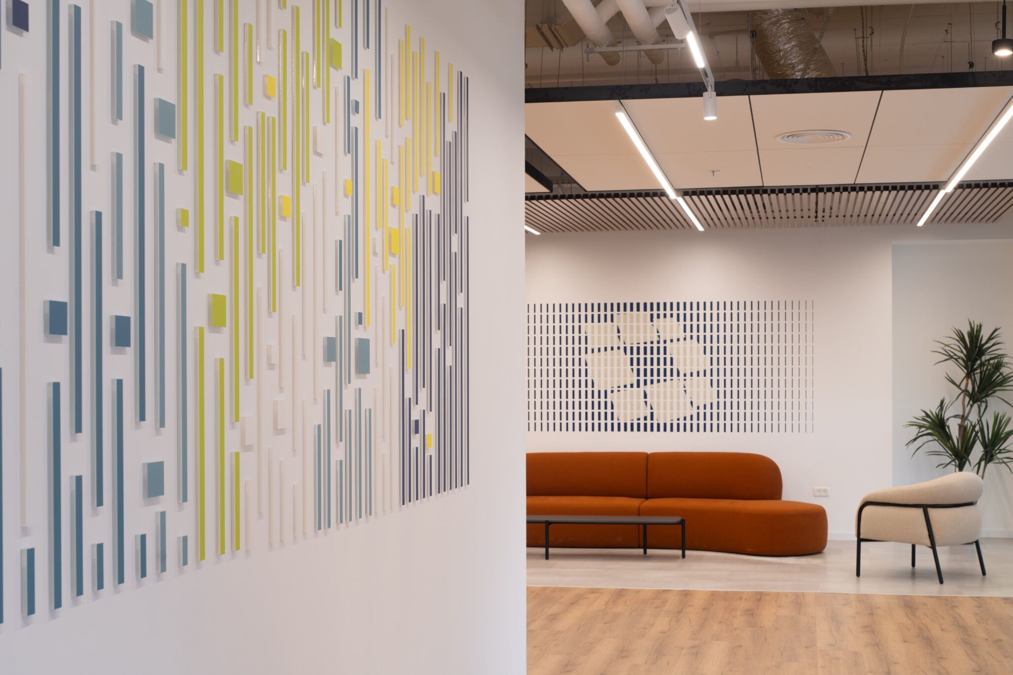 Coloured bar relief wall and a slat panel logo in a lounge