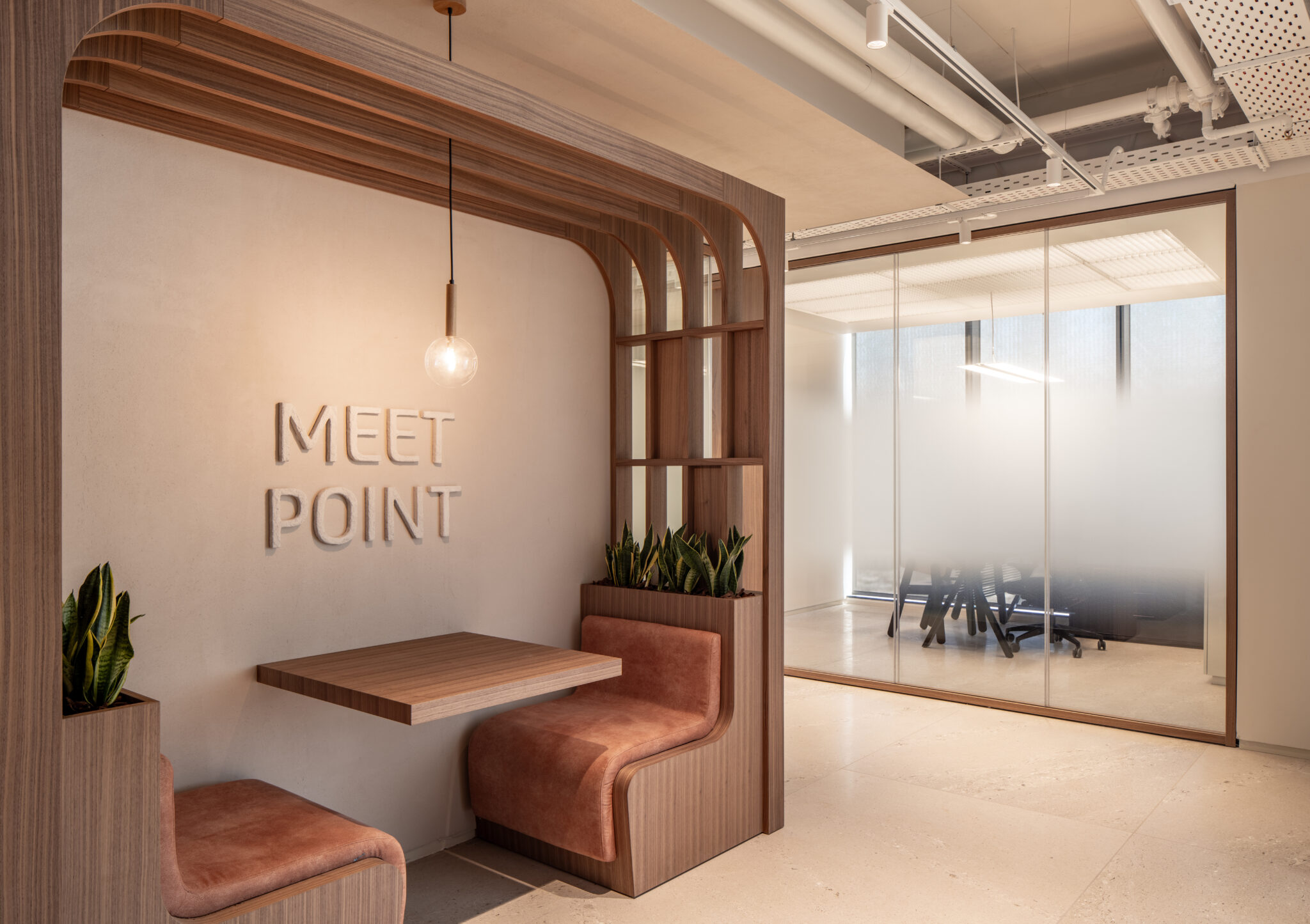 MEET POINT 3D letters in a seating booth beside frosted glass