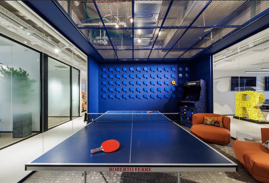 Blue relief wall panel of repeated shapes in a games room