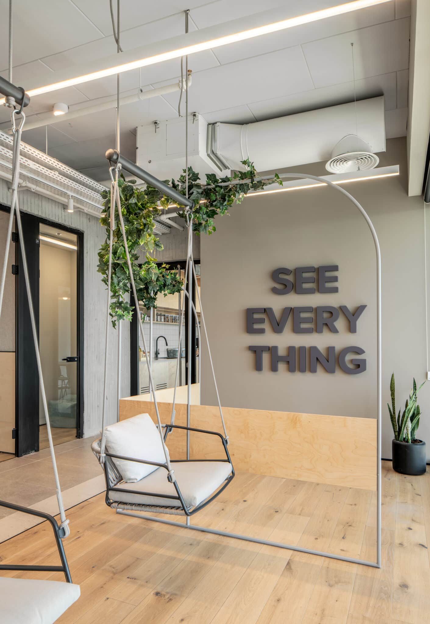 SEE EVERY THING 3D letters on a wall beside a swing seat