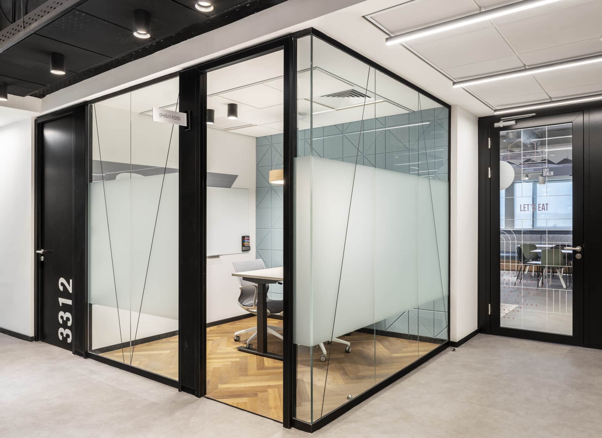 Line pattern film on meeting room glass with room number signage