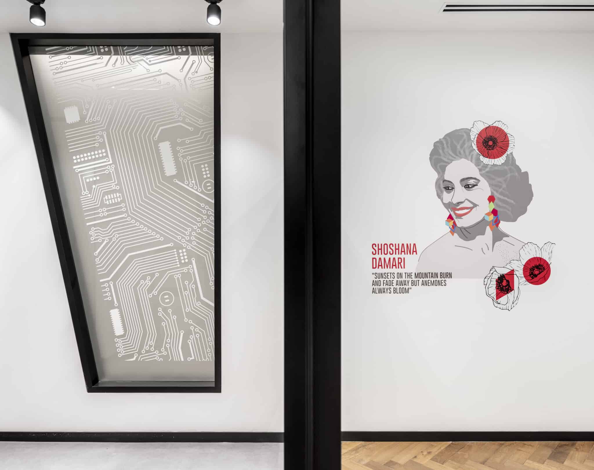 Circuit pattern film on glass beside a portrait wall graphic