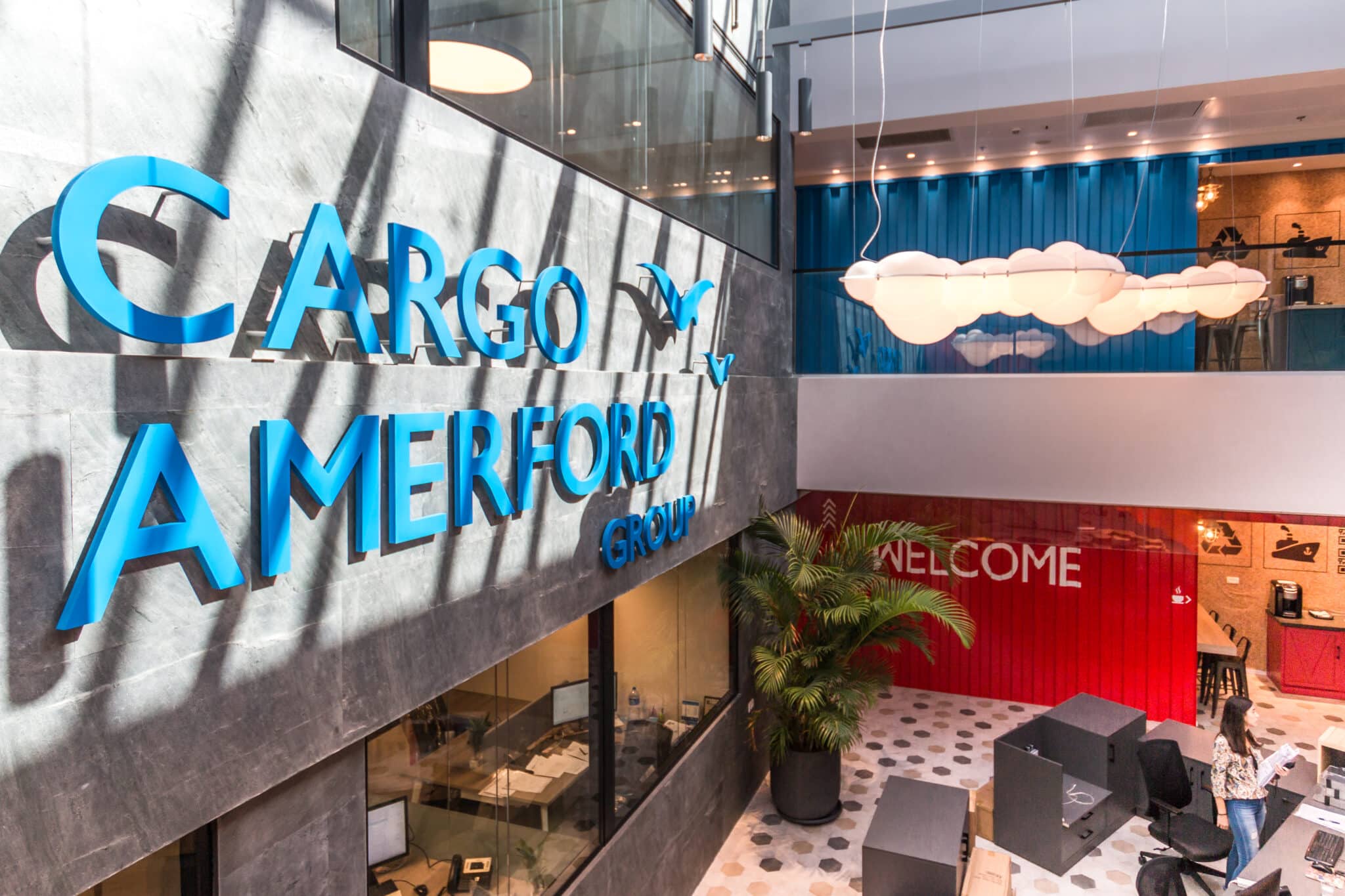 Blue 3D logo letters overlooking the atrium and a WELCOME wall