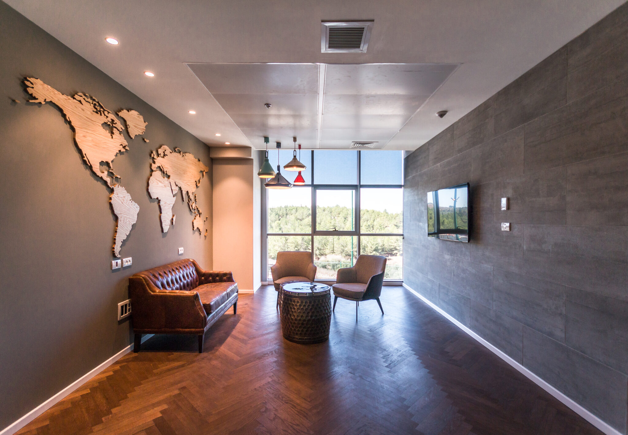 3D wood world map mounted on a dark lounge wall