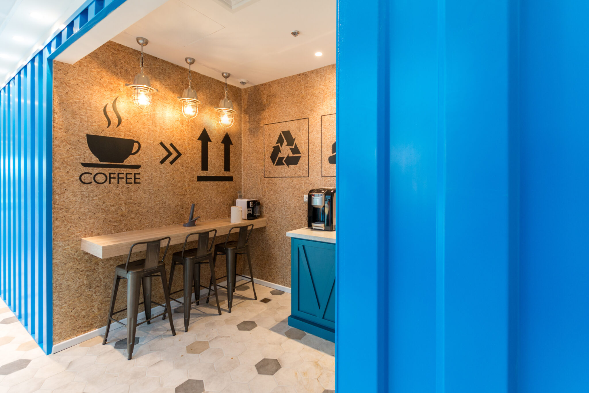 COFFEE pictogram wall graphics above a coffee point counter