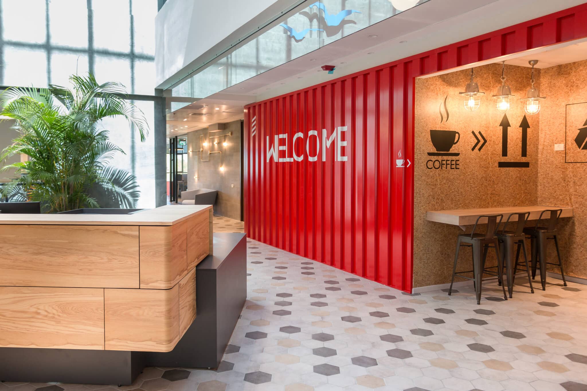 WELCOME 3D letters on a red container wall with coffee signage