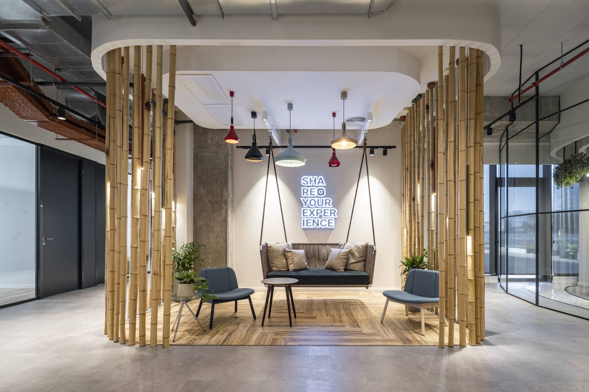 SHARE YOUR EXPERIENCE lightbox sign in a bamboo screened lounge