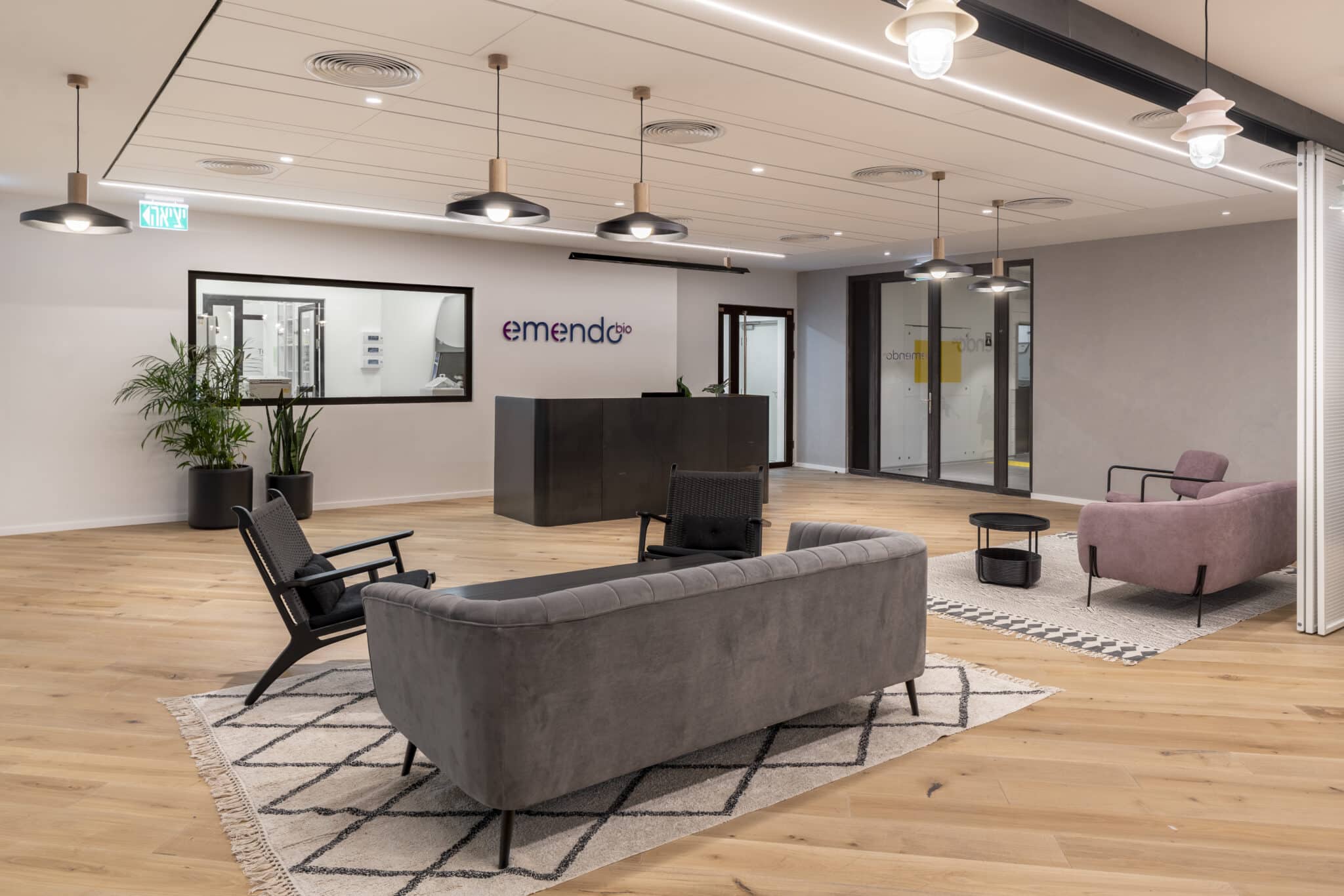 emendo logo on the reception wall above a dark desk