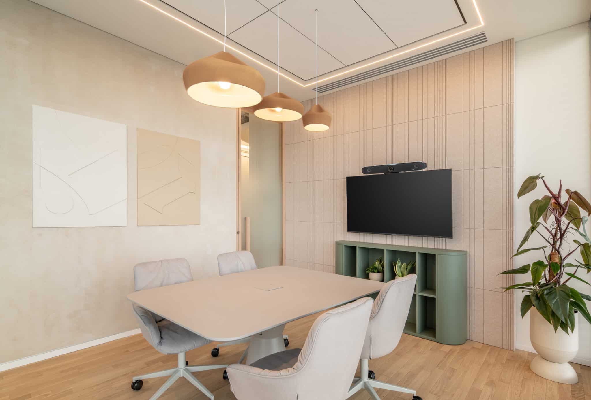Framed line artwork beside a reeded timber wall in a meeting room
