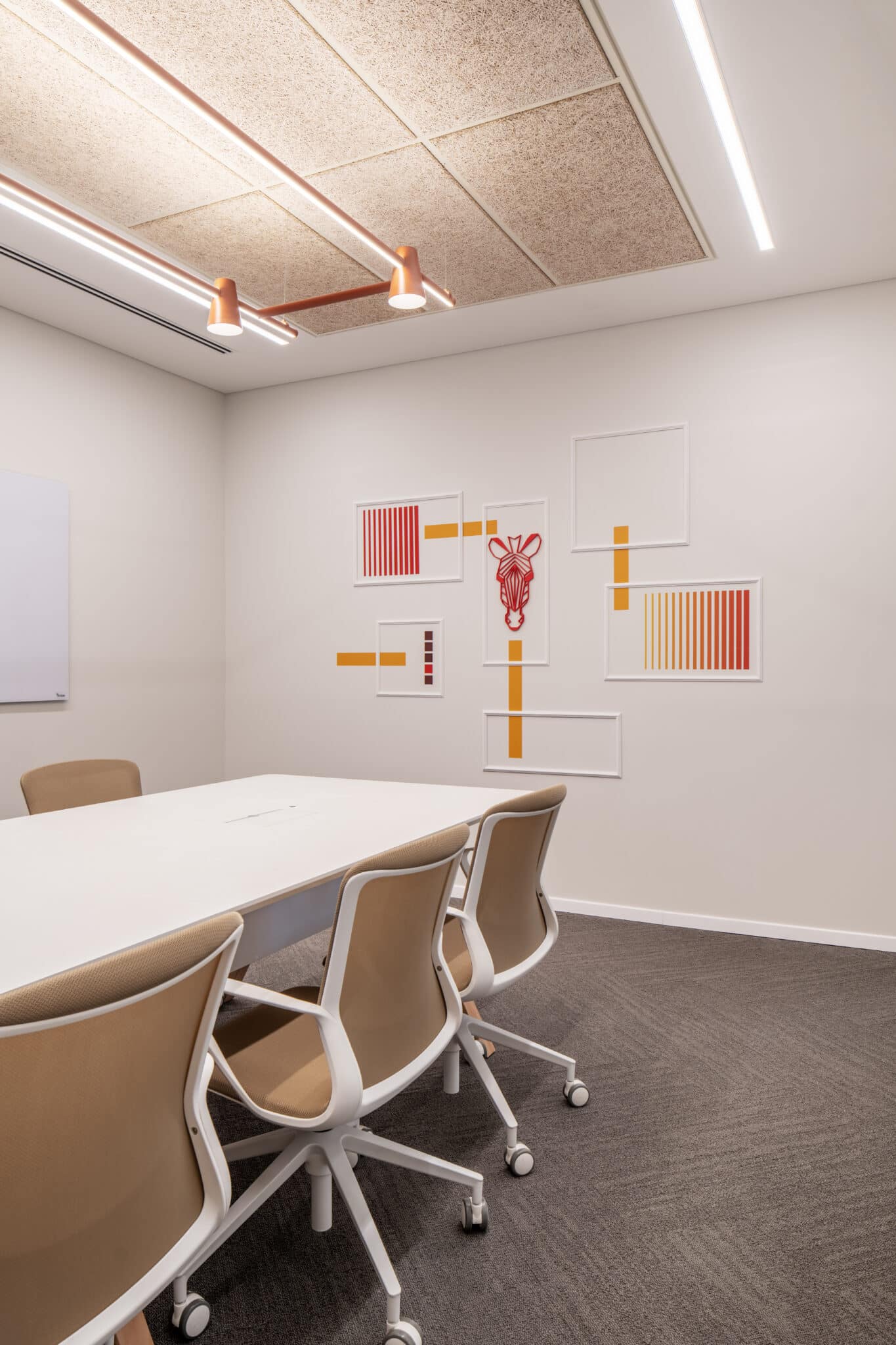 Framed artwork on a wall in an office corridor