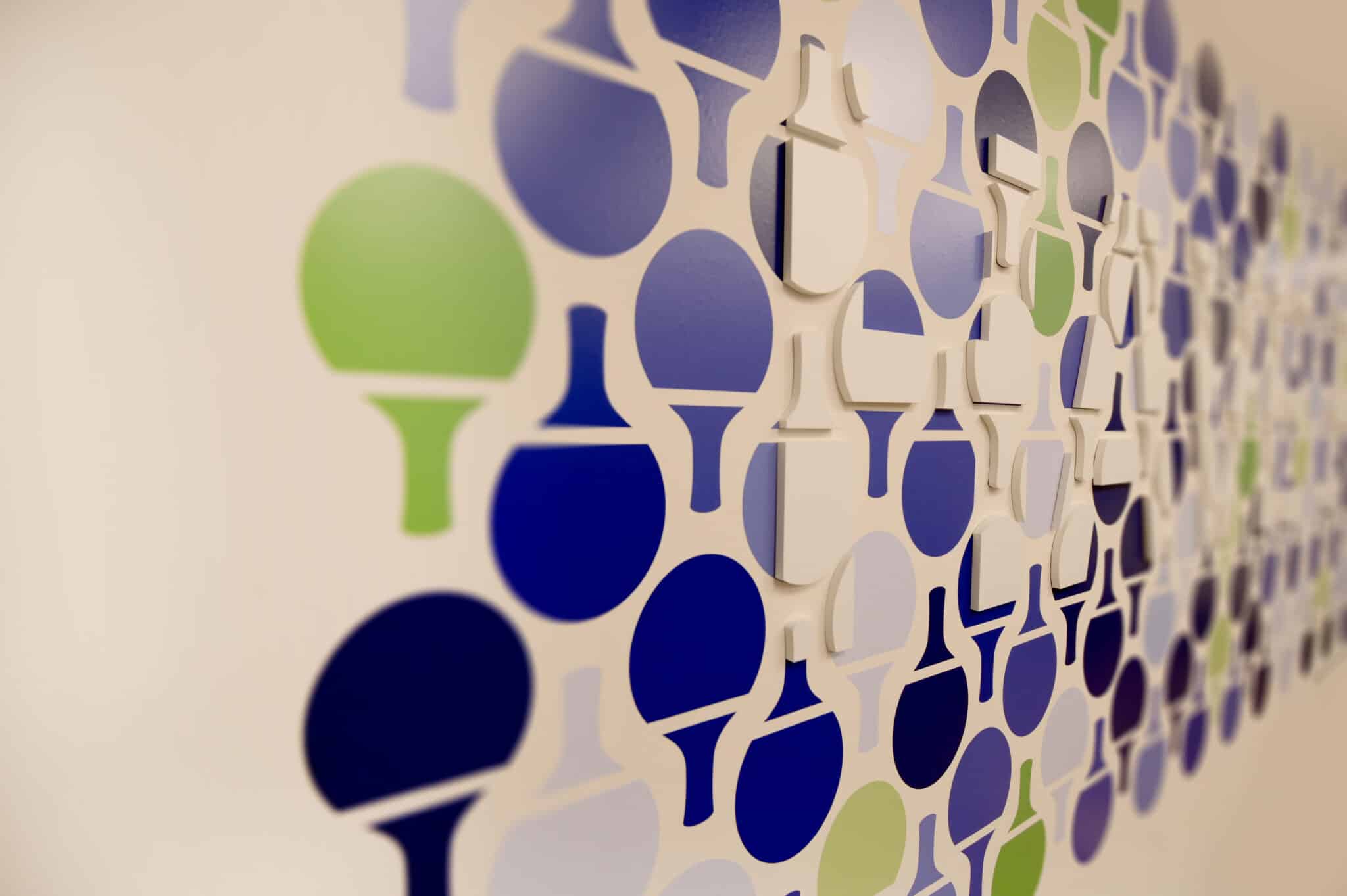 Close-up of 3D ping pong paddle shapes on a wall