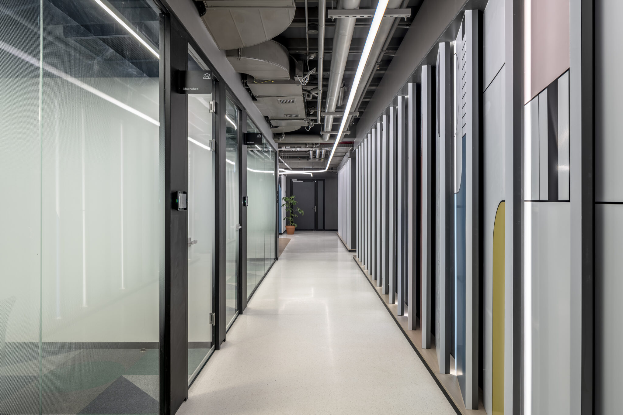 Decorative glass coating with gradient and wall graphics along a corridor