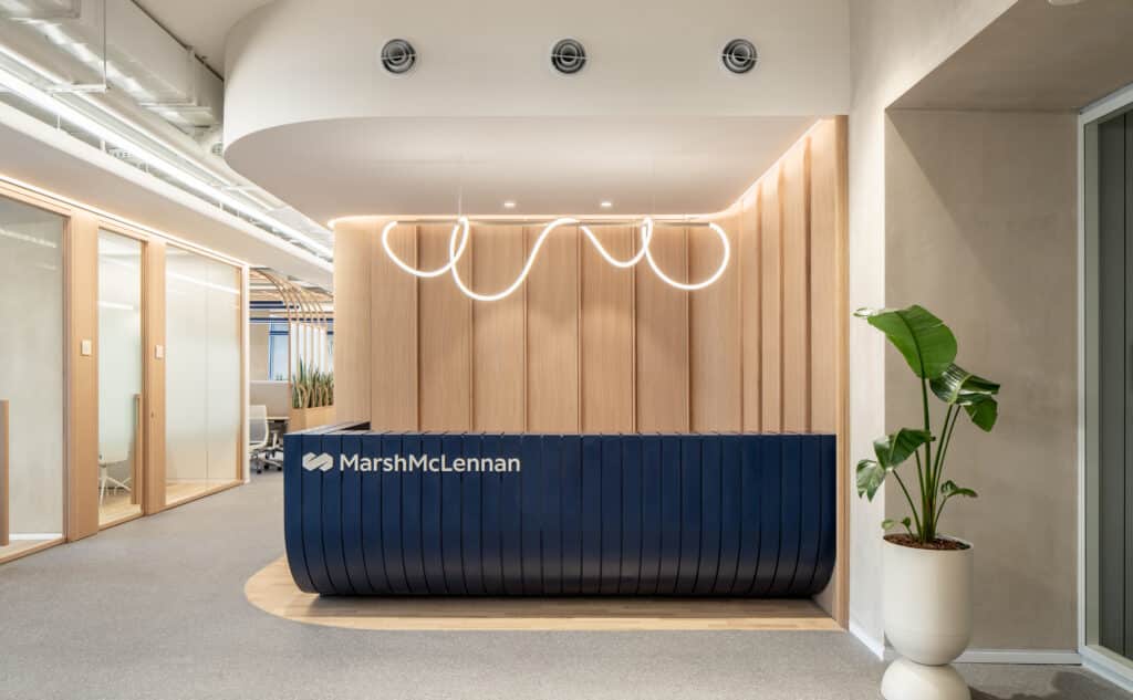 MarshMcLennan logo on the reception desk with a neon light above