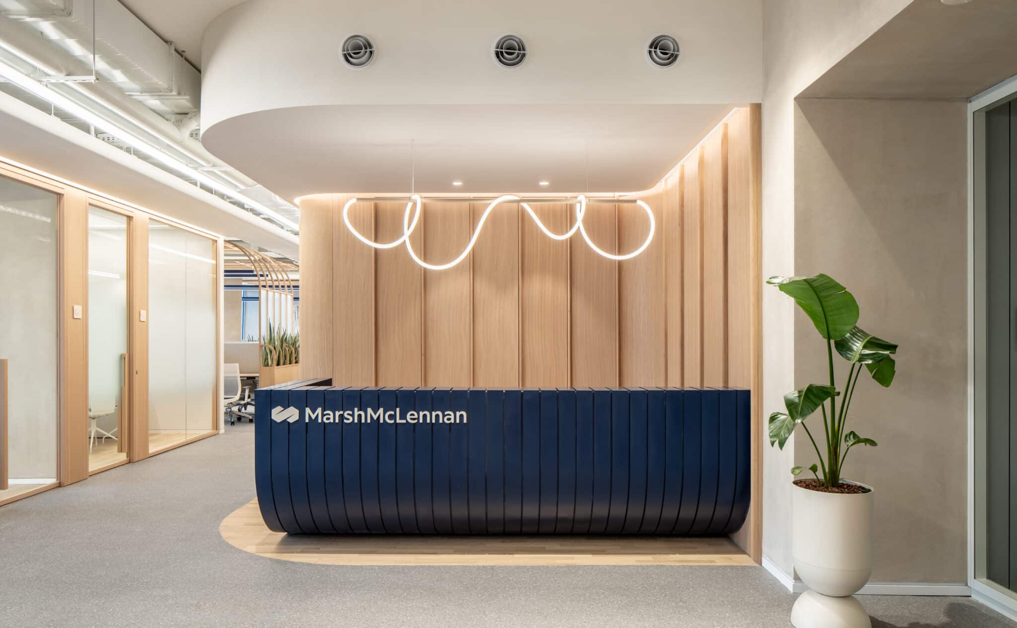 MarshMcLennan logo on the reception desk with a neon light above