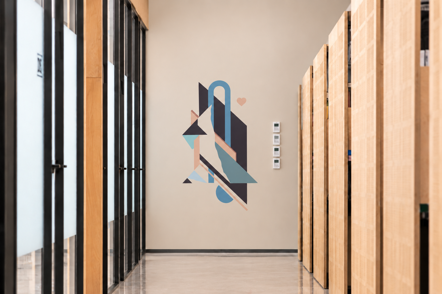 Abstract geometric wall graphic at the end of an office corridor