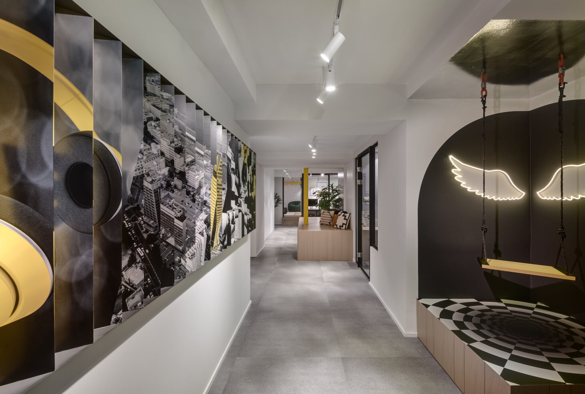 Neon wings lit element and a printed slat wall in a corridor