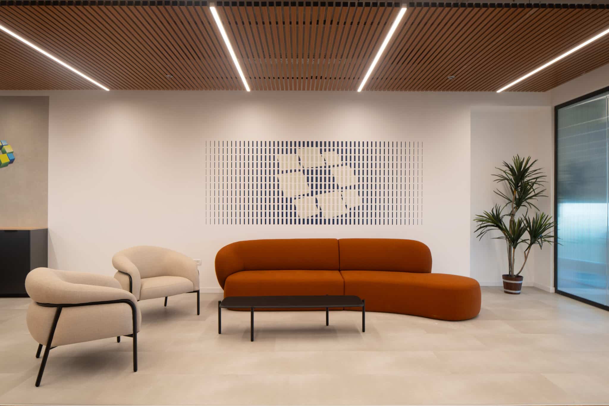 Framed grid artwork in navy and white above a lounge sofa