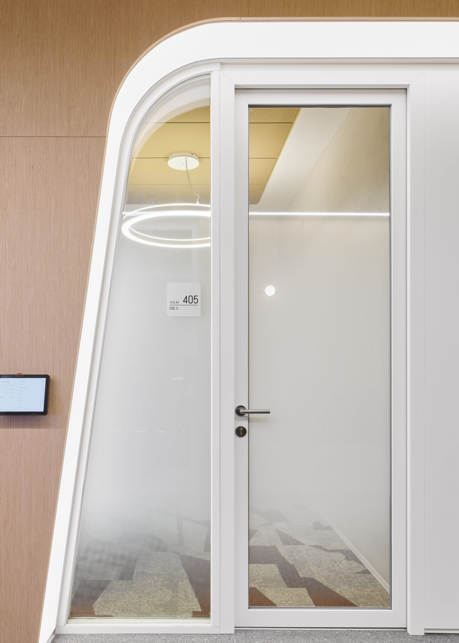 Room number sign on a curved glass meeting pod