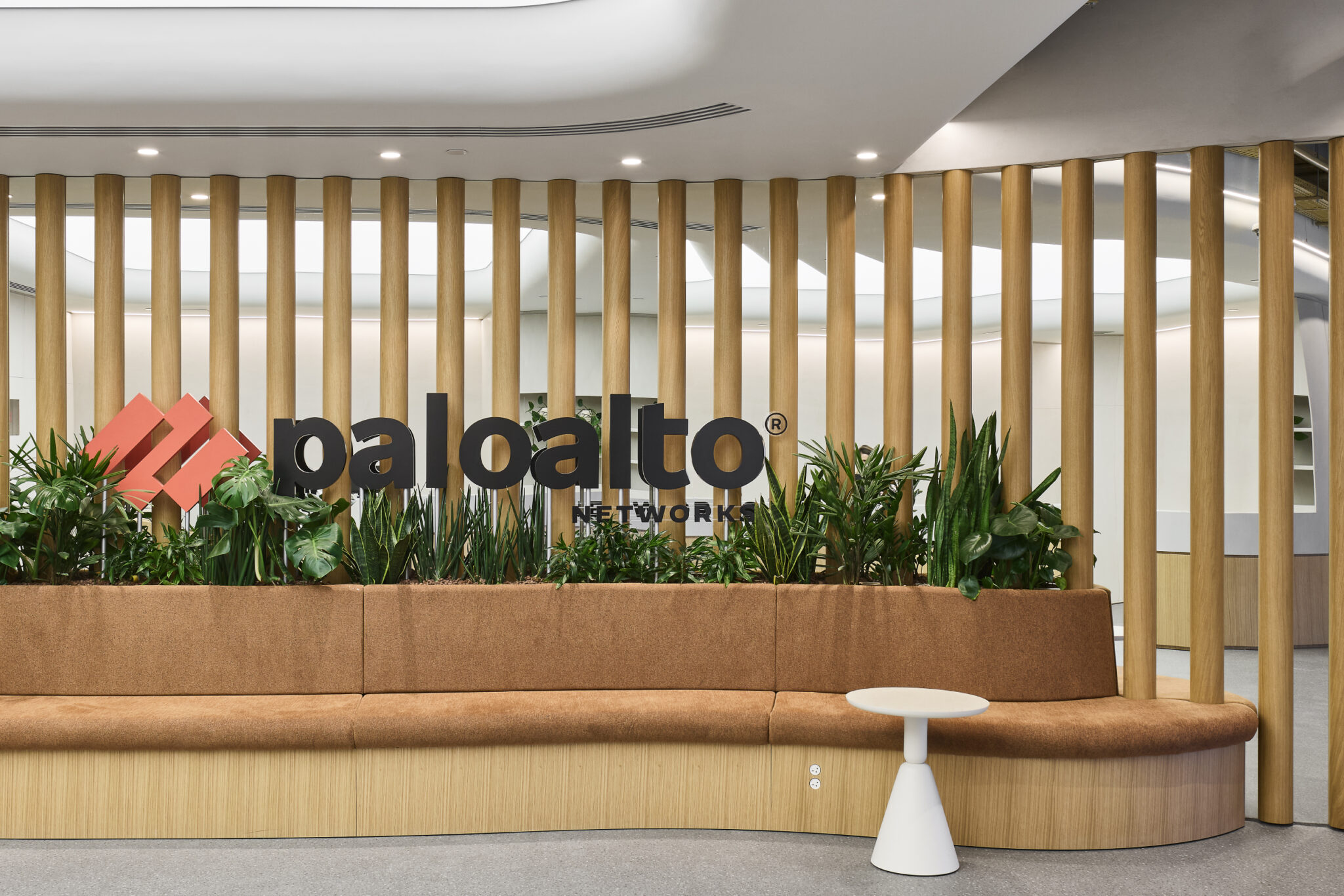 paloalto logo on a slatted timber wall behind a planted bench