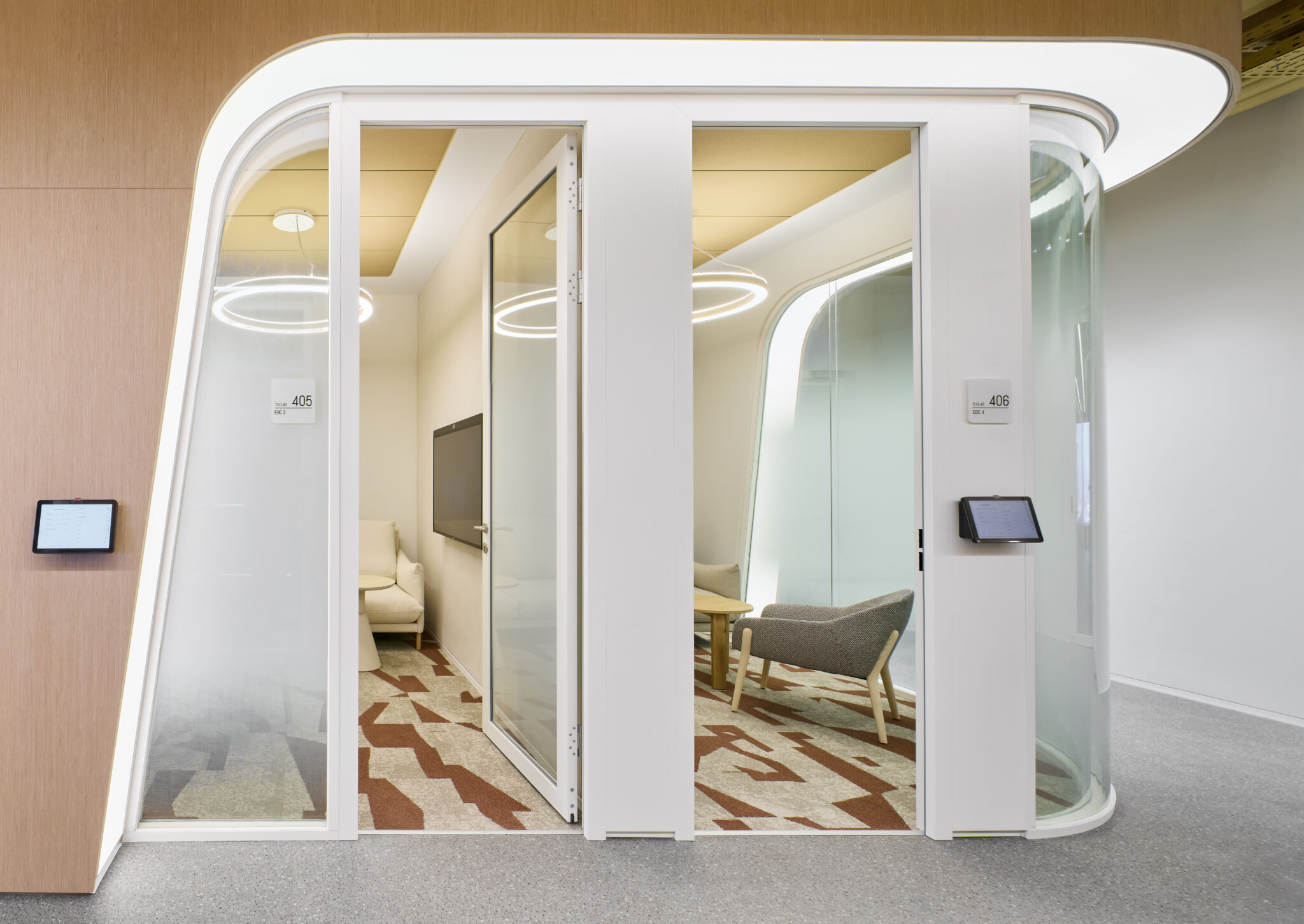 Room number signs on curved glass meeting pods