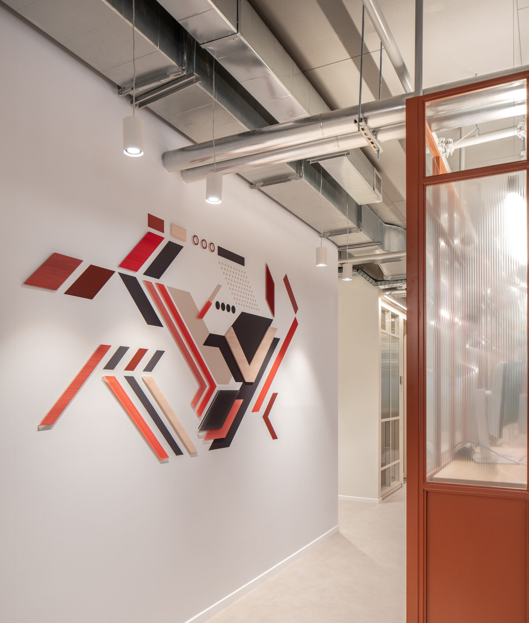 3D angled bars in red and wood forming a wall relief
