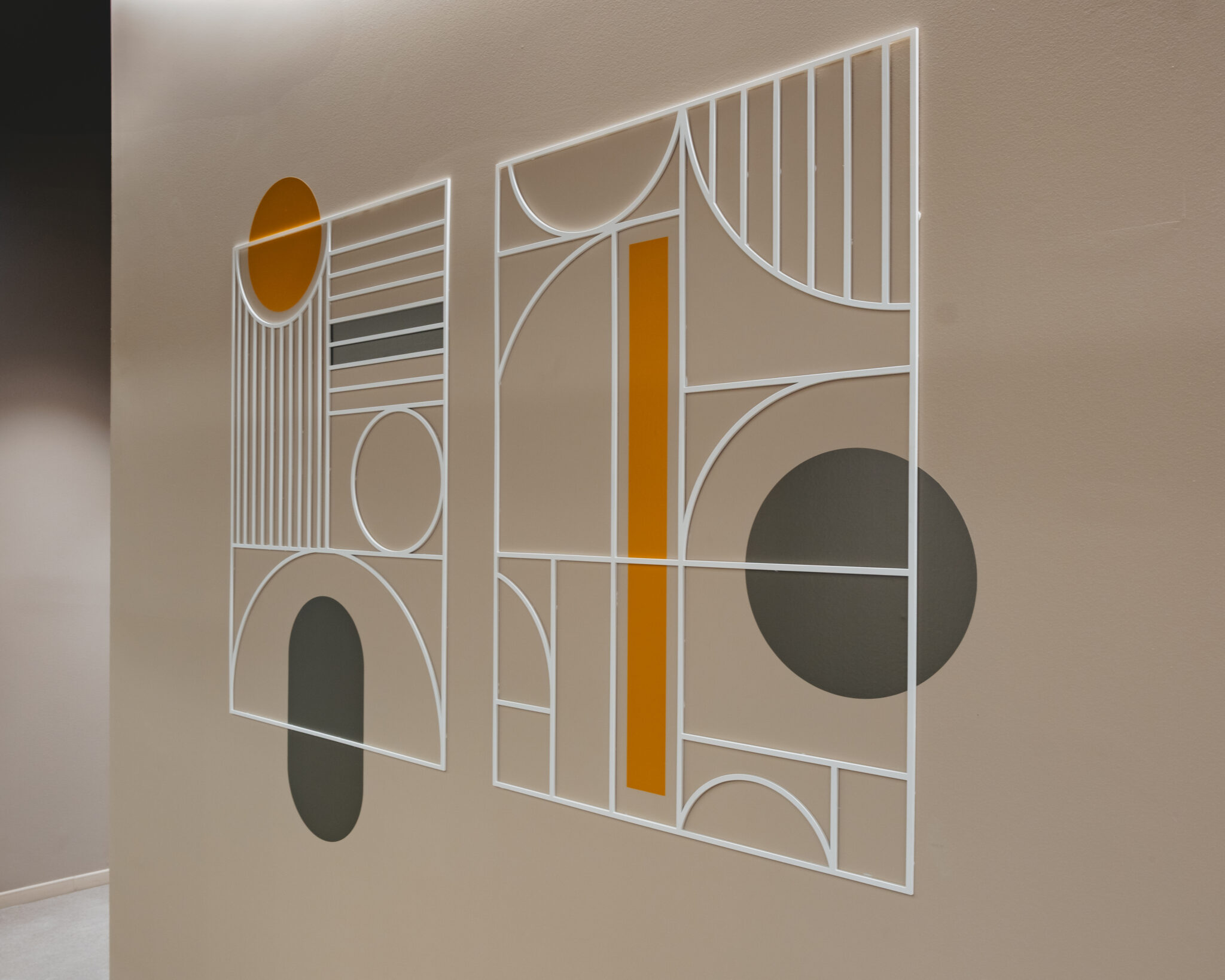 Geometric line wall graphic with orange and grey shapes