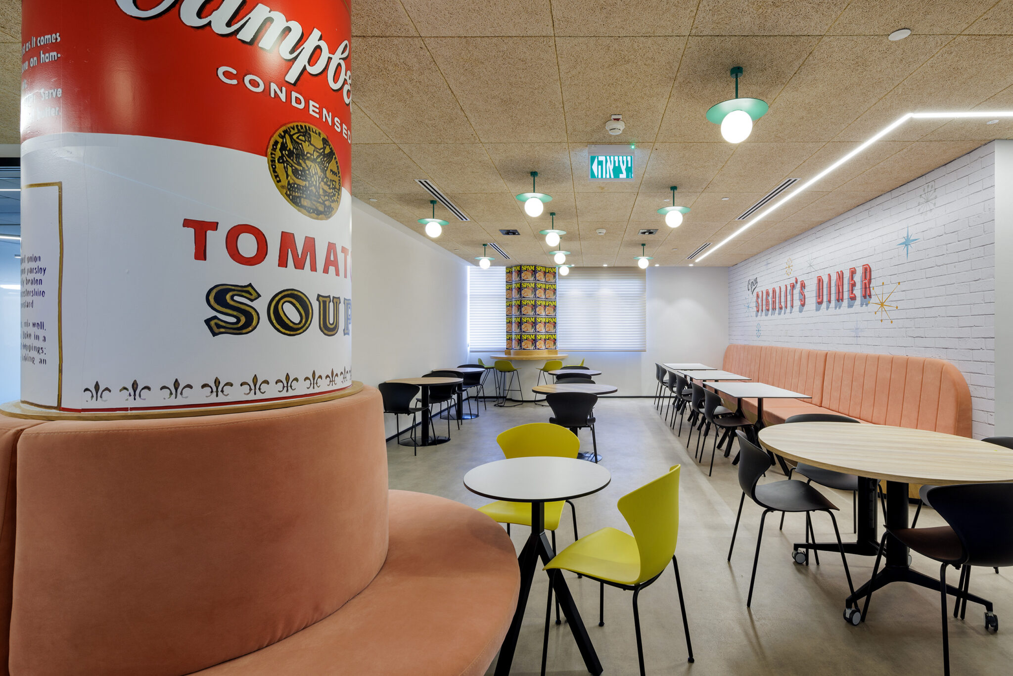 Giant soup can graphic and a diner sign in the office dining area