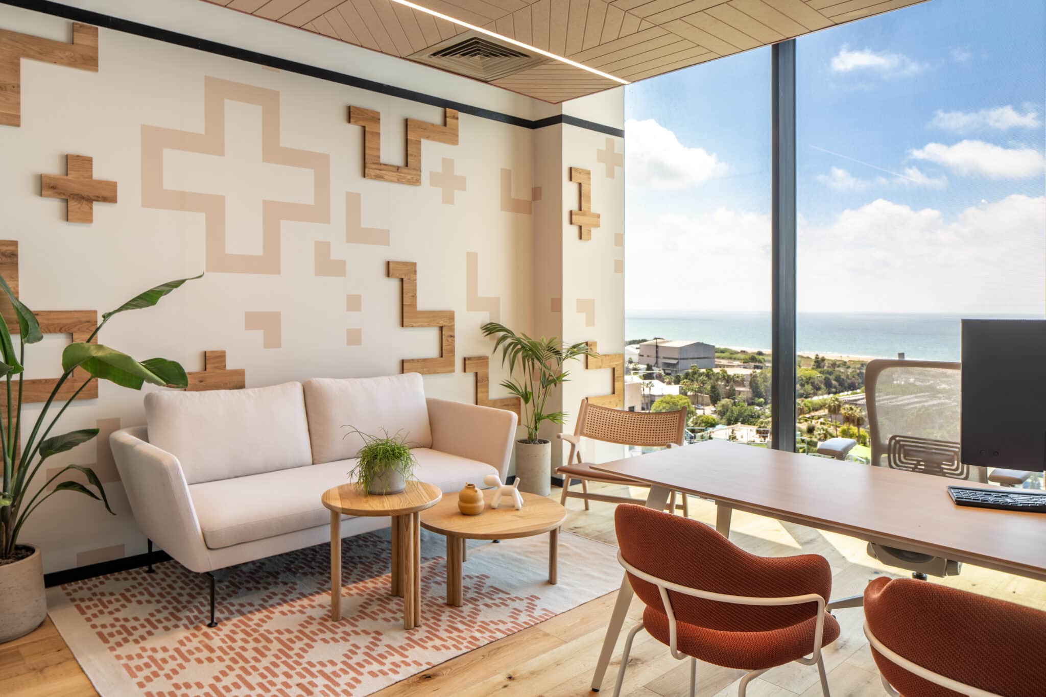 Wood and painted cross shapes on an office lounge wall