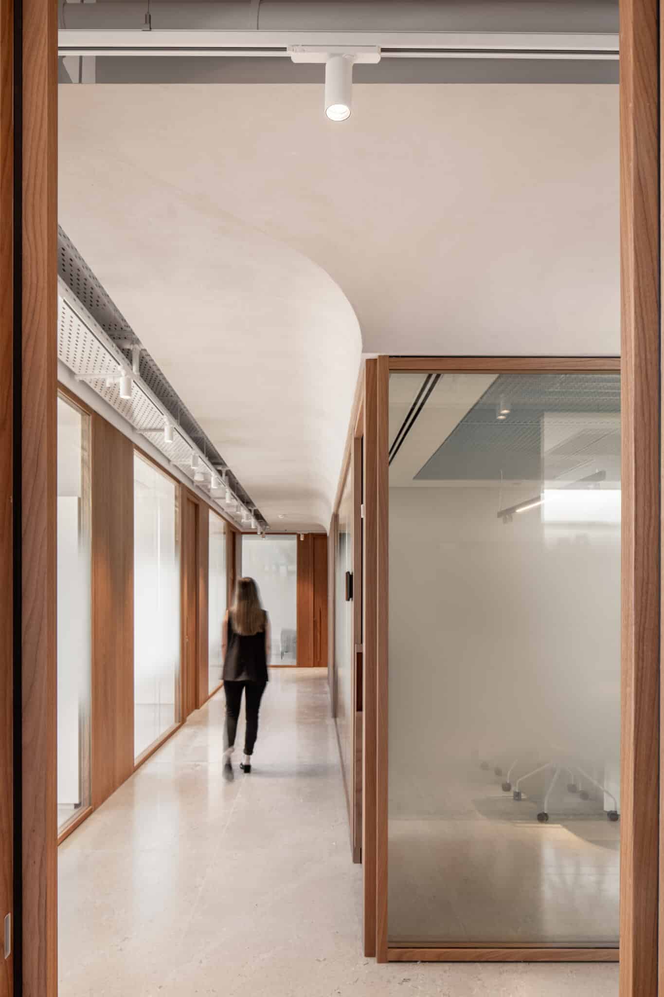 Frosted glass panels in wood frames along a corridor