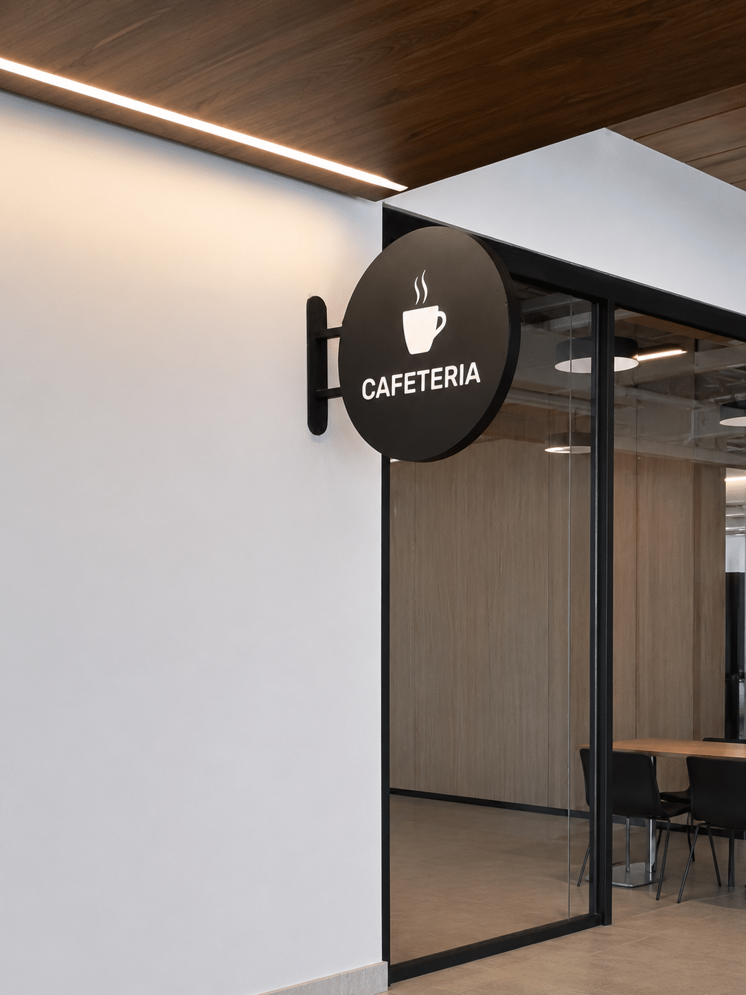 Round black CAFETERIA blade sign with a cup pictogram