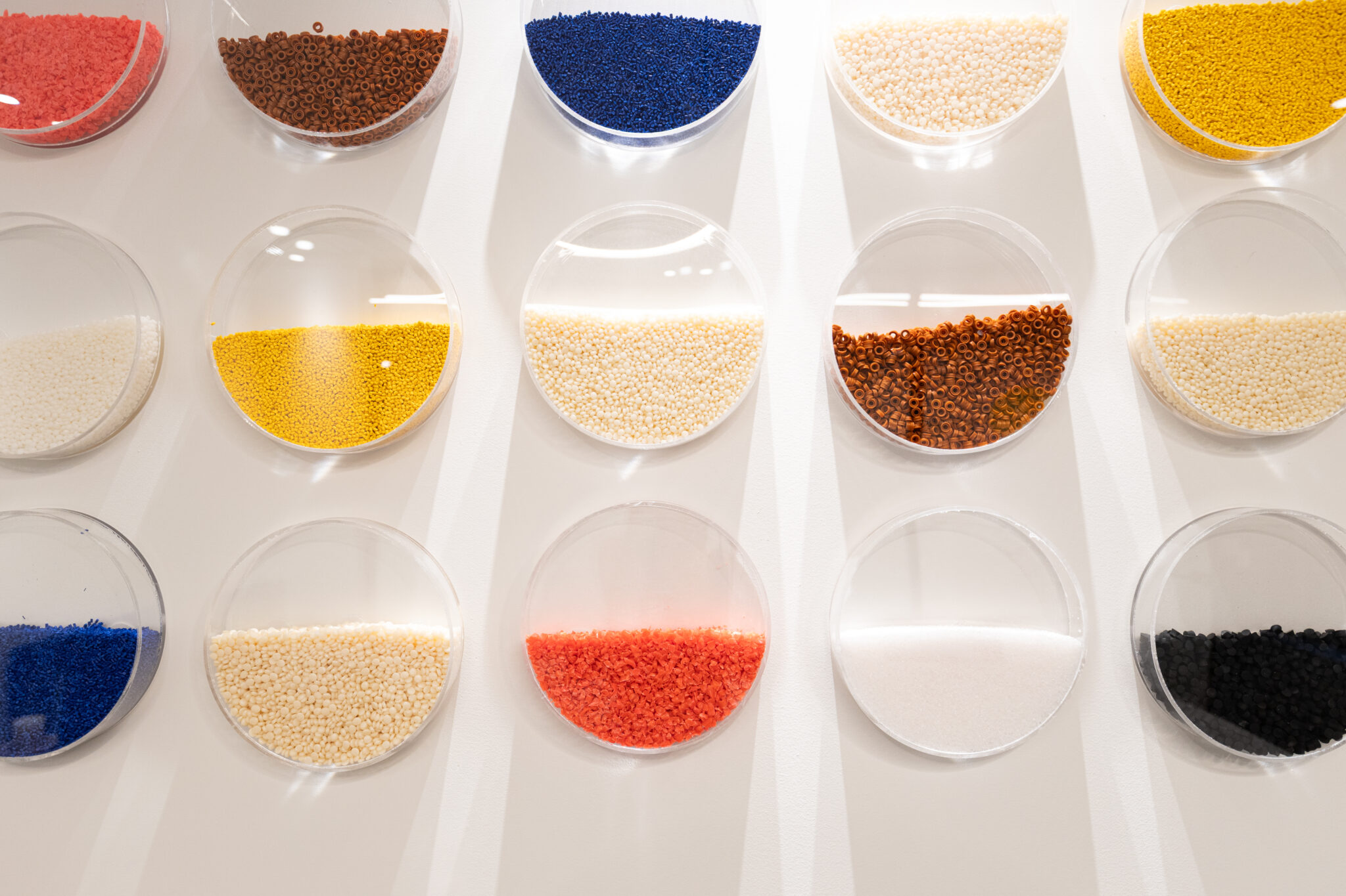Wall display of dishes filled with coloured plastic granules
