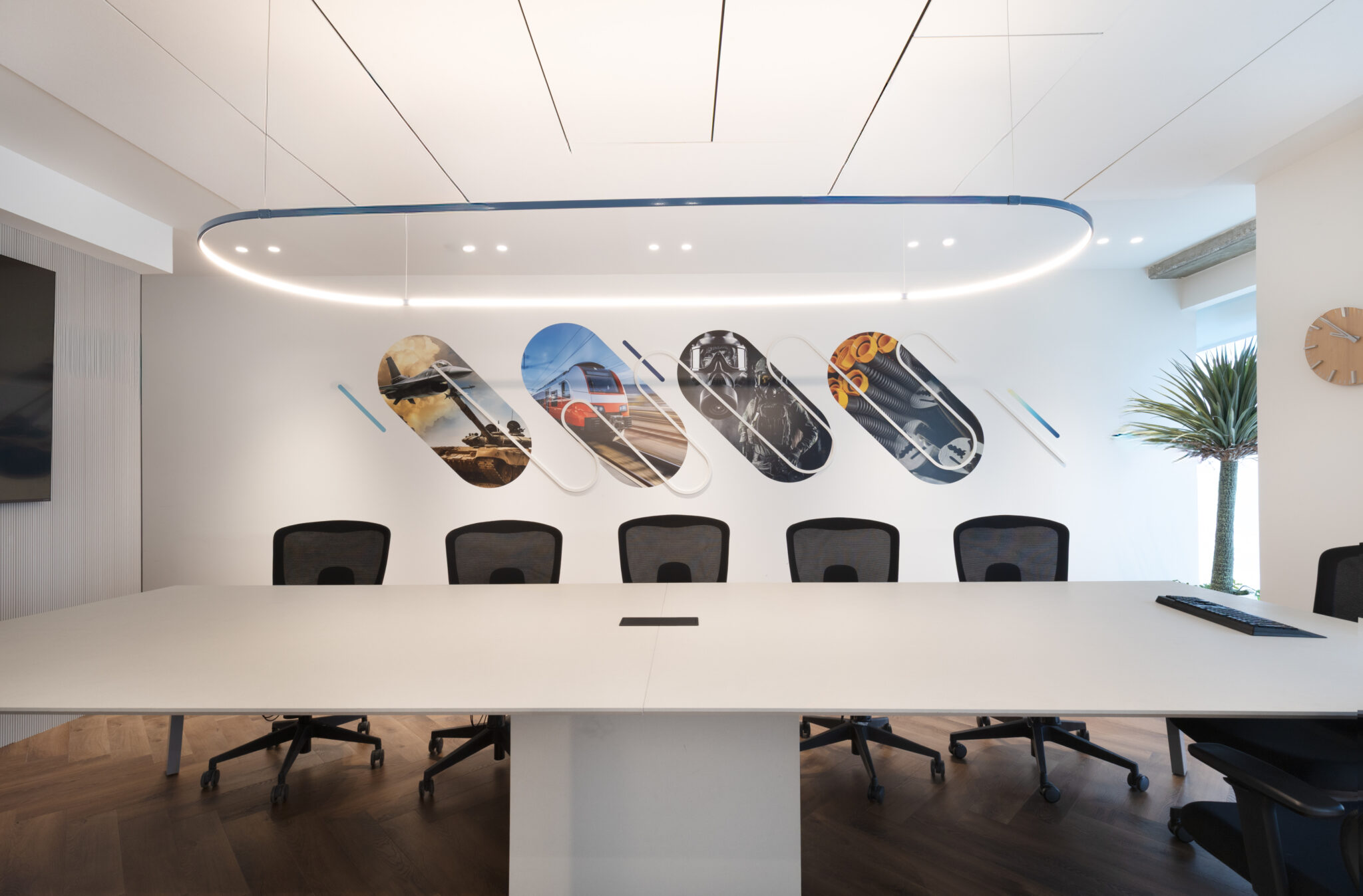 Four capsule-shaped printed panels on a meeting room wall