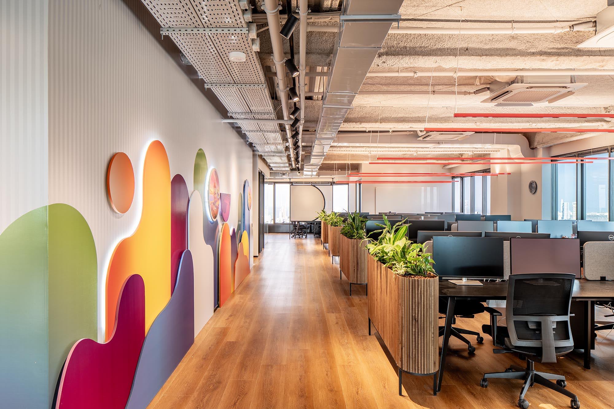 Layered colour shape wall along an open plan office corridor