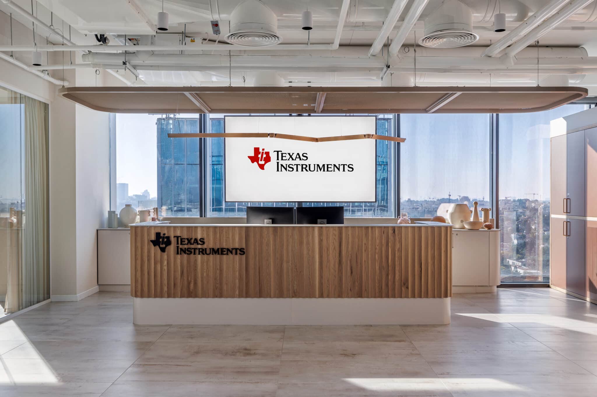 Texas Instruments logo on the reception wall and on the fluted desk front