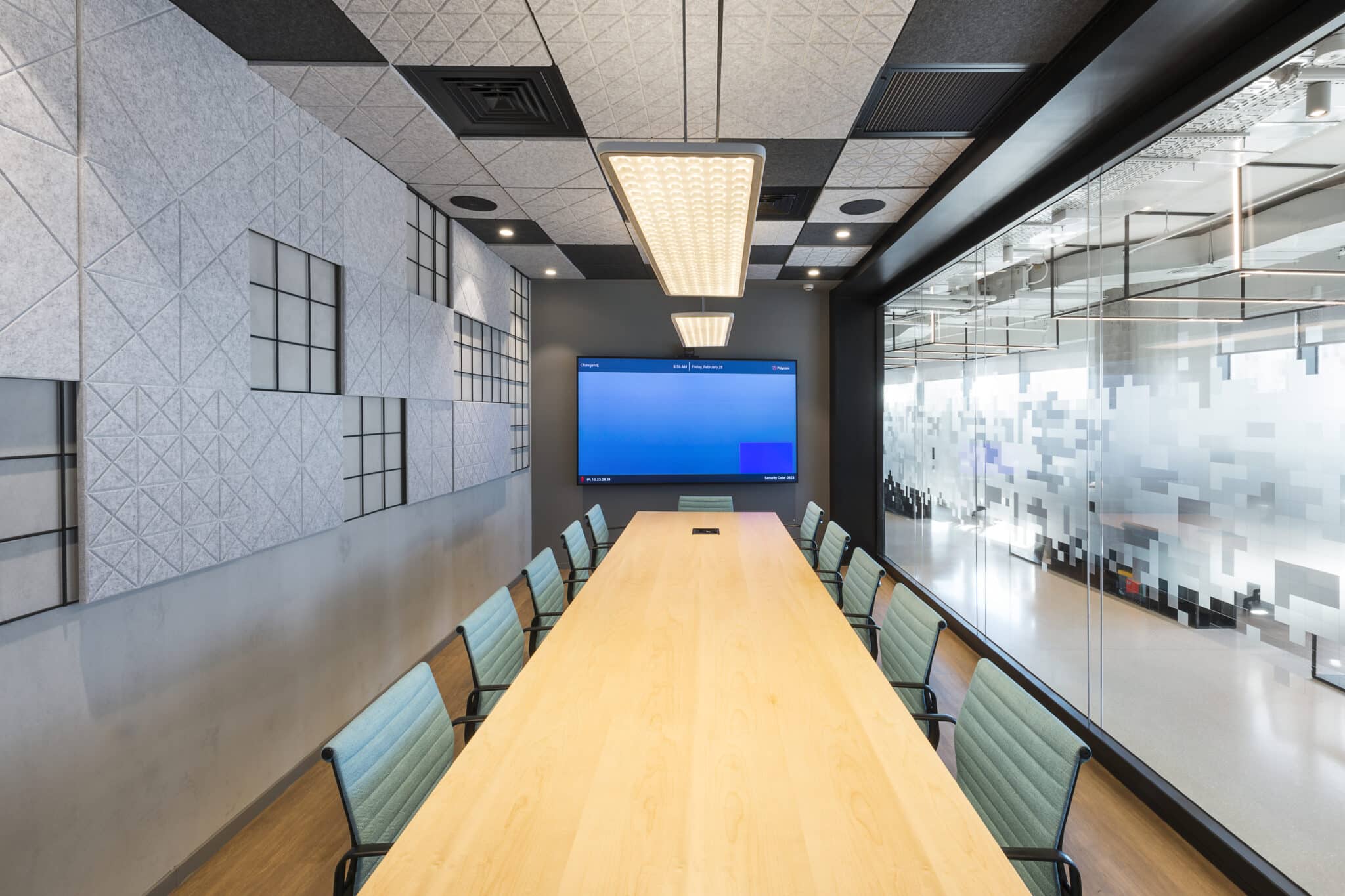Grey acoustic felt panels on the wall and ceiling of a meeting room