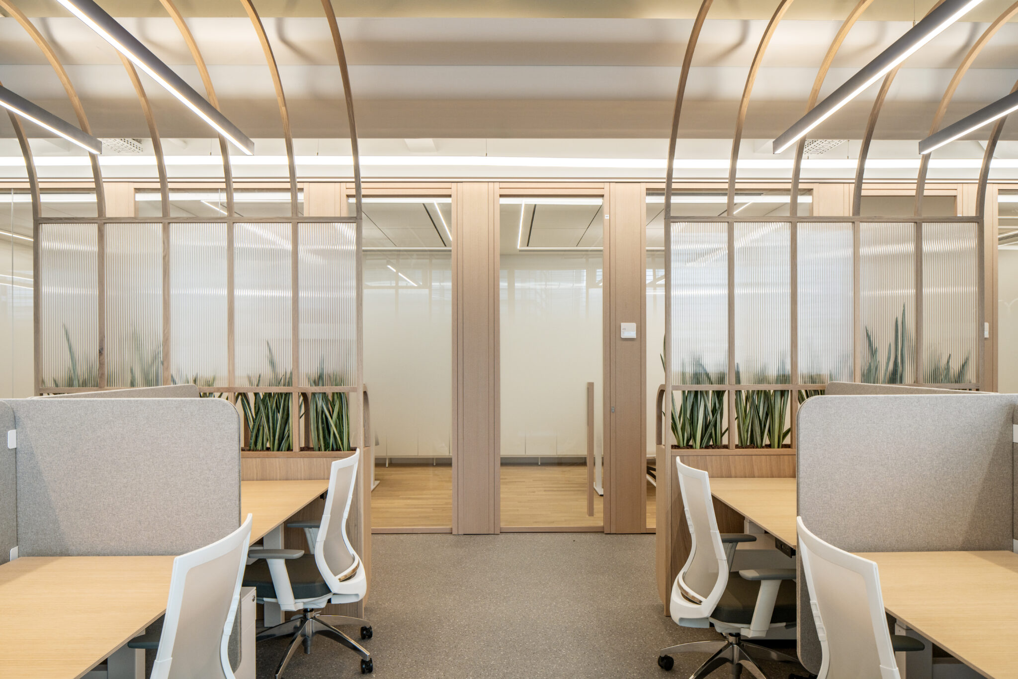 Fluted glass partitions in wood frames around a work area