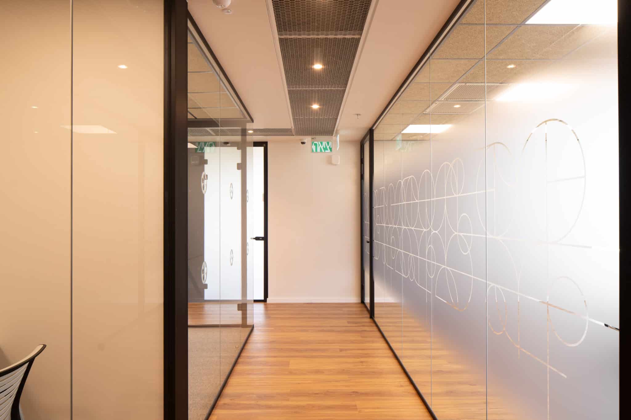 Quote lettering printed on frosted glass beside a lounge