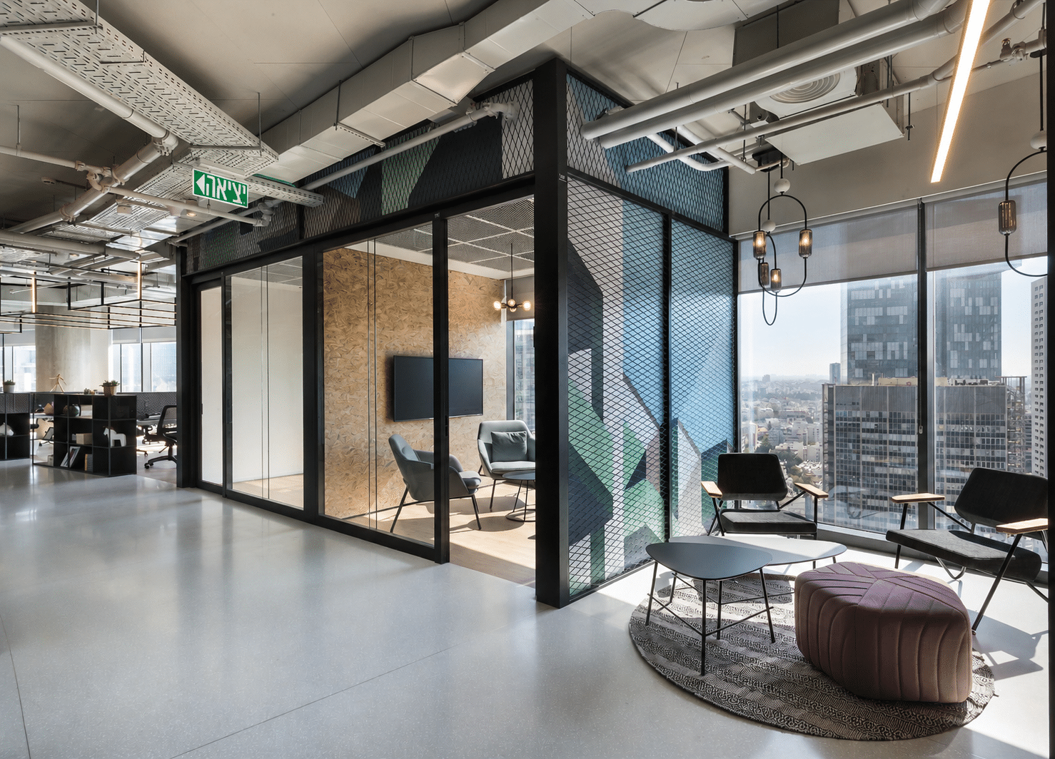 Geometric printed glass in green and blue around a meeting room