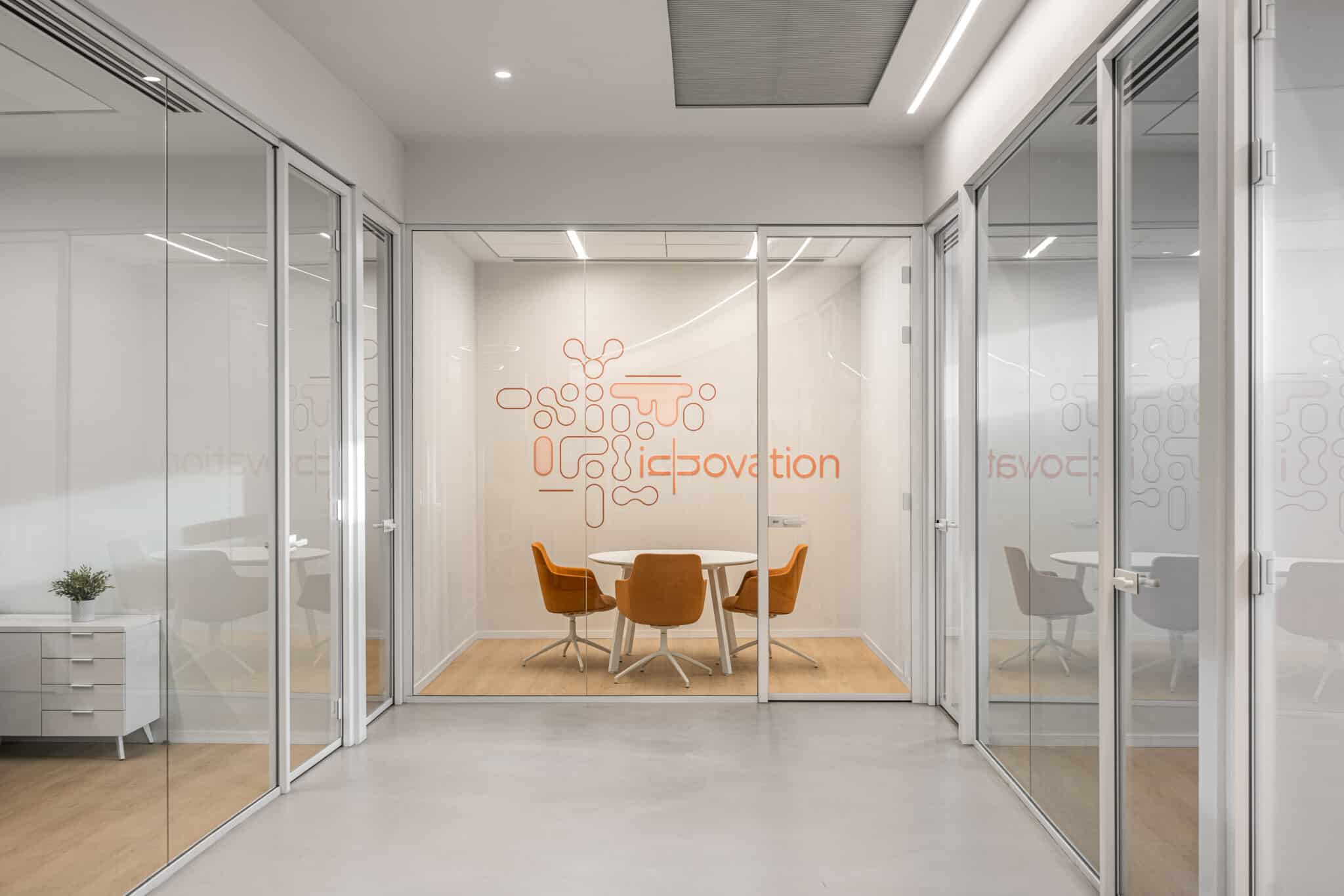 Orange rounded wall graphic in a glass meeting room