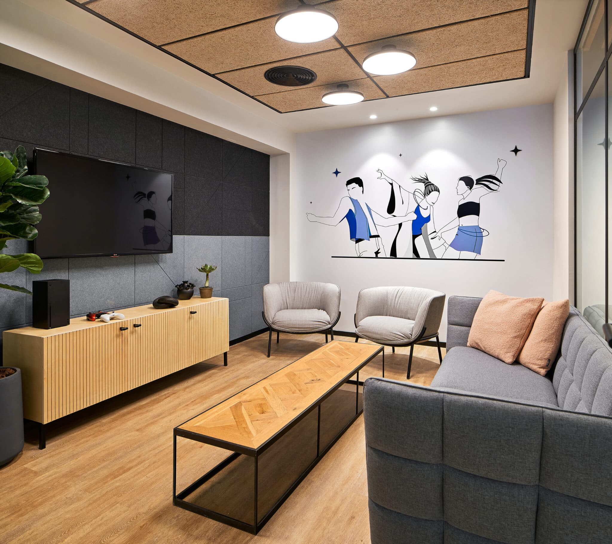 Wall graphic of three figures above a lounge sofa
