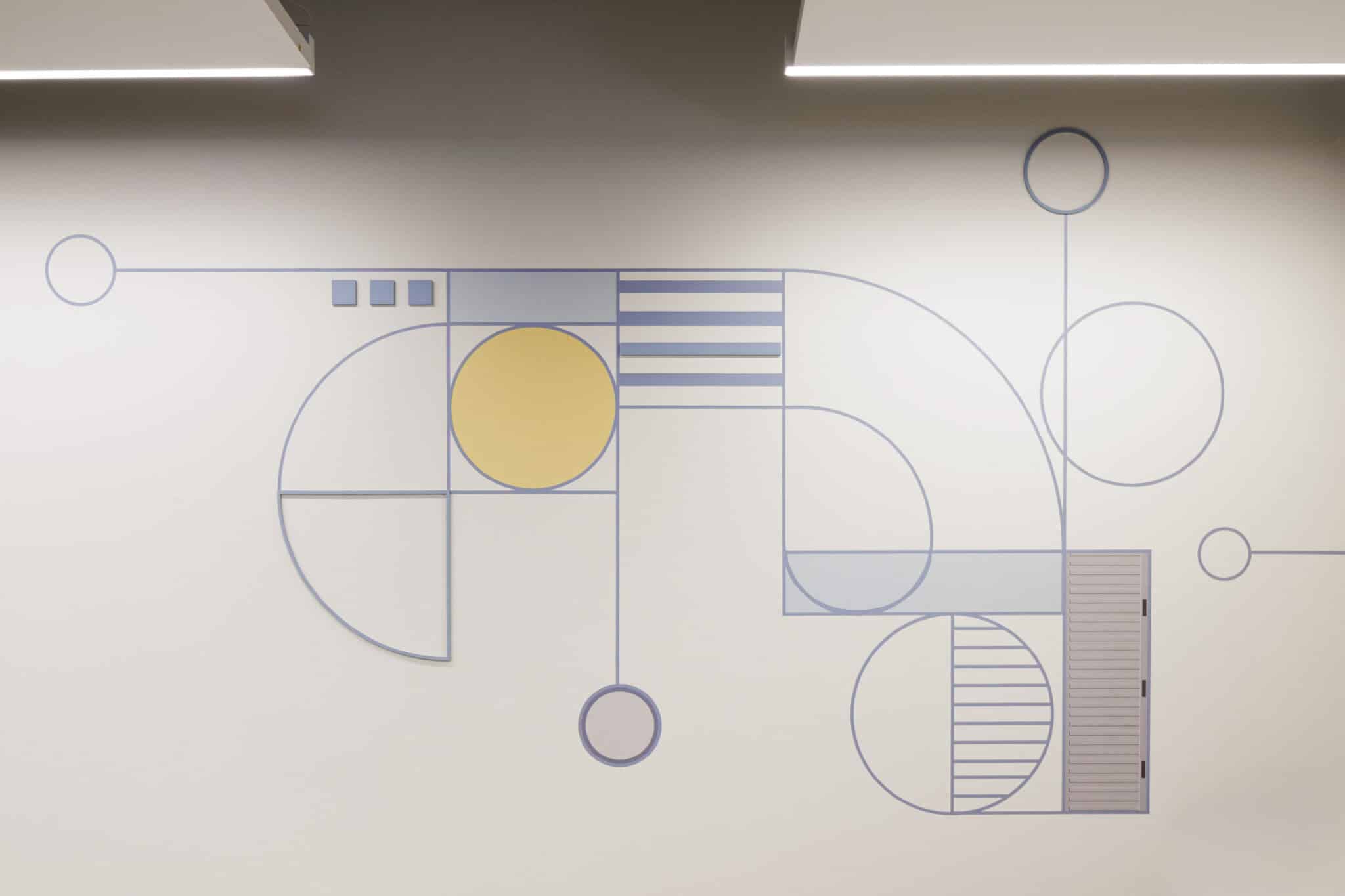 Blue and yellow geometric line wall graphic in an office