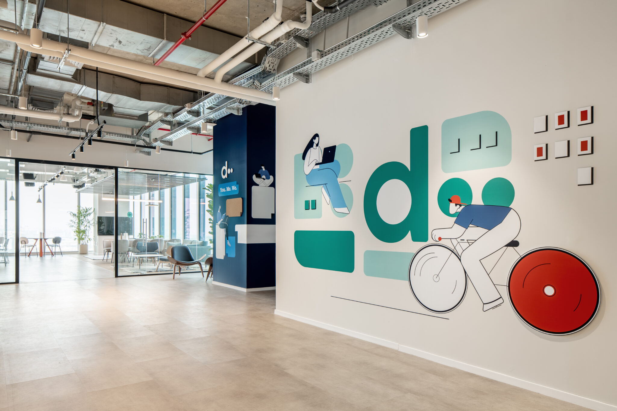 Illustrated wall graphic of a cyclist with a red 3D wheel
