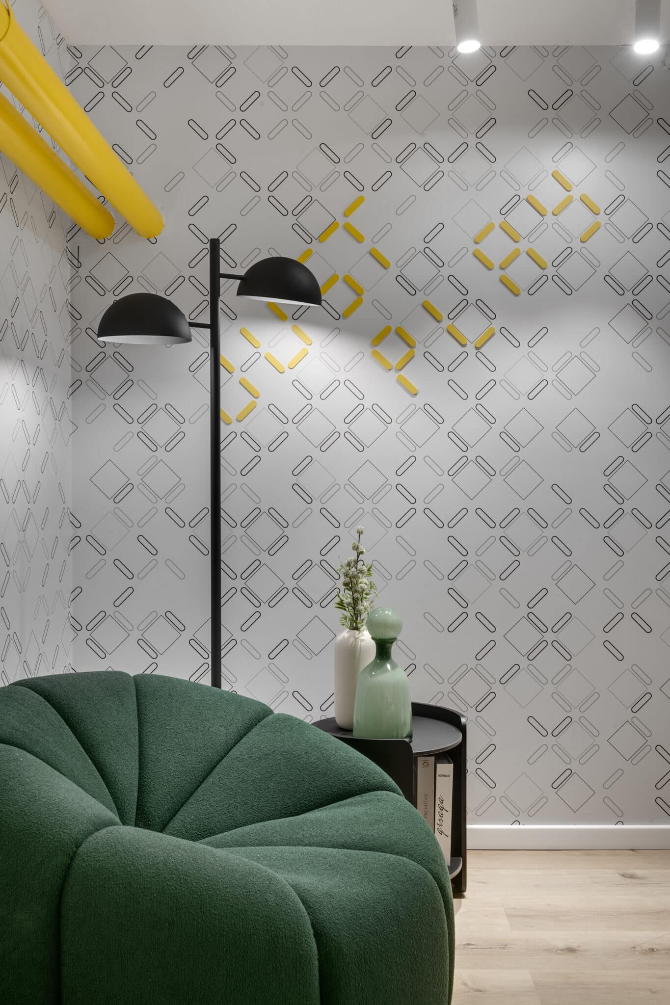 Patterned wallpaper graphic with yellow accents in a lounge corner